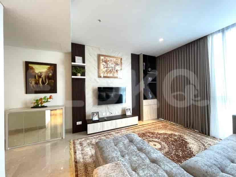 Living room entertainment area with a wall-mounted TV and decorative elements.