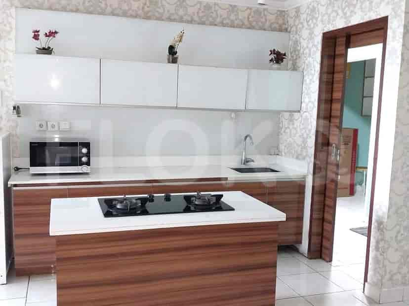 Modern kitchen with white cabinetry and a central island.