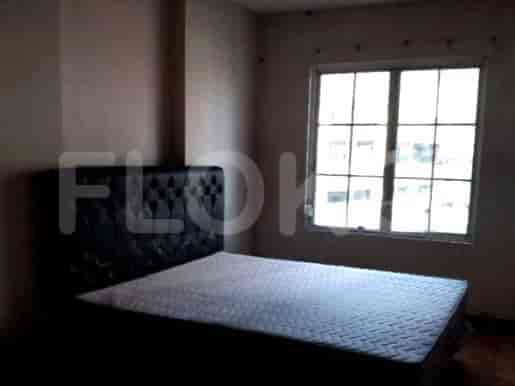 Bedroom with a simple bed and a window.