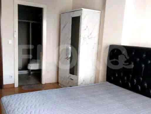 Bedroom with a bed, wardrobe, and a bathroom entrance.