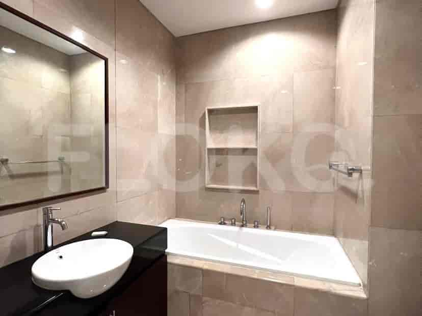Bathroom featuring a bathtub, vanity, and a large mirror.