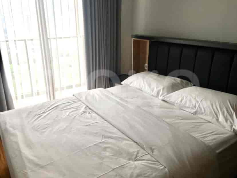 A bedroom featuring a double bed with white linens and a dark headboard.