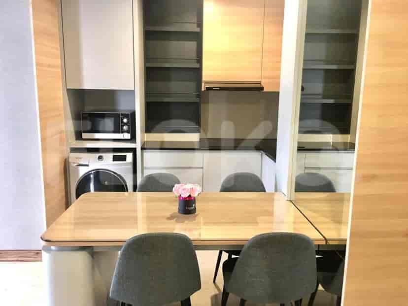 A modern dining area and kitchen featuring a dining table and modern appliances.