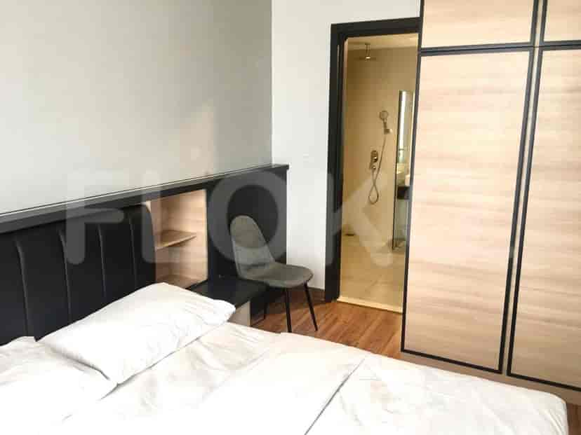 Bedroom with a bed, chair and access to a bathroom.