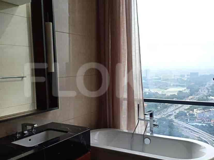 A bathroom with a bathtub, a sink, and a view.