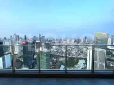 Balcony with panoramic city views, glass railing.