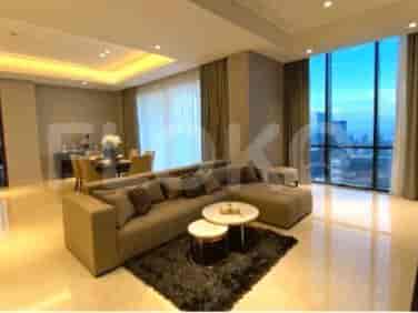 Luxurious living area with an L-shaped sofa, city view, and modern design.