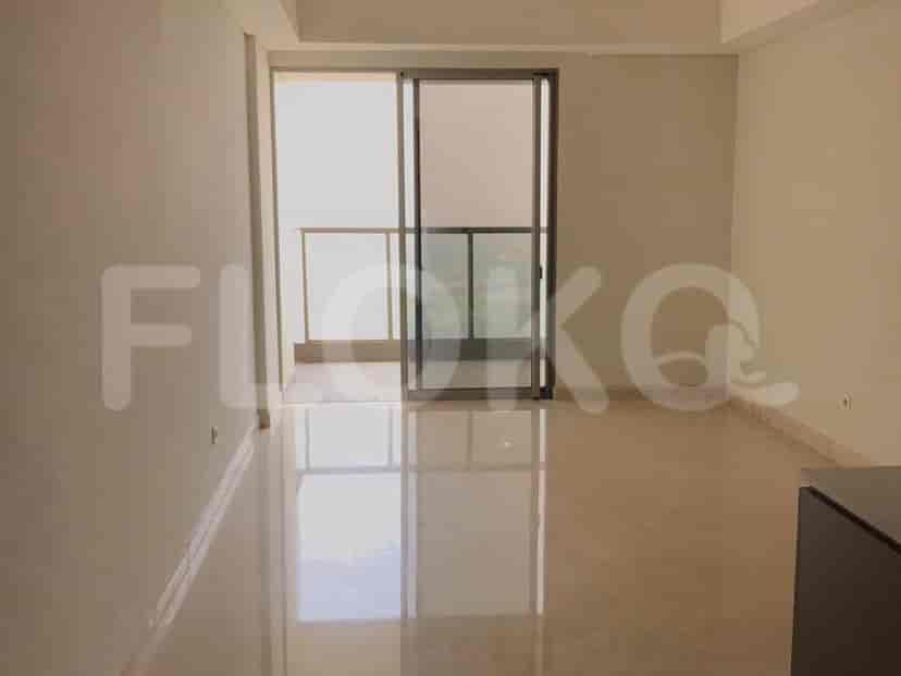 A bright living space with large windows and a balcony access.
