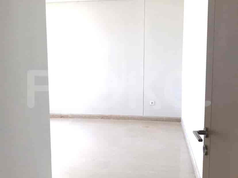 A hallway leading to a room, with neutral tones and a minimalist style.