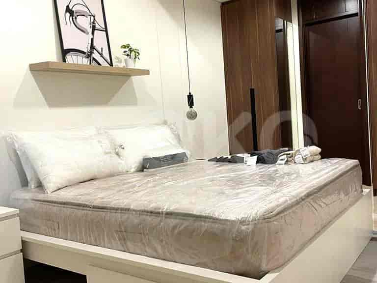 Bedroom with a bed, nightstands, and a bicycle-themed art piece.