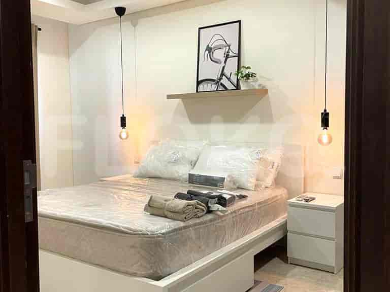 Bedroom with bed, lamps, and minimalist decor.
