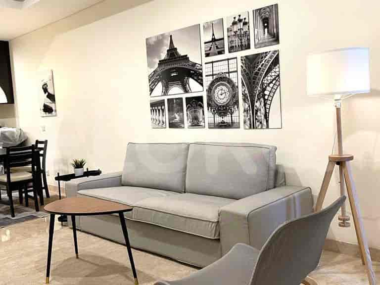 Living room with grey sofa, artwork, coffee table, and floor lamp.