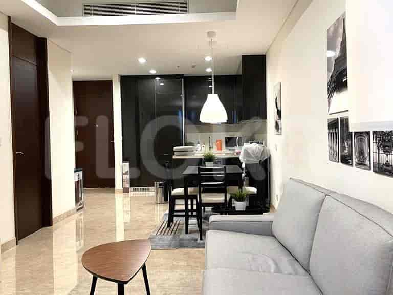 Open kitchen layout with dining table, chairs, and a black kitchen design.