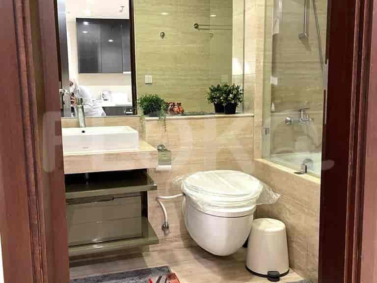 Bathroom with sink, toilet, and a shower.