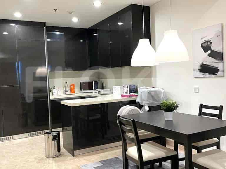 Kitchen and dining area with black cabinets, dining table, and chairs.