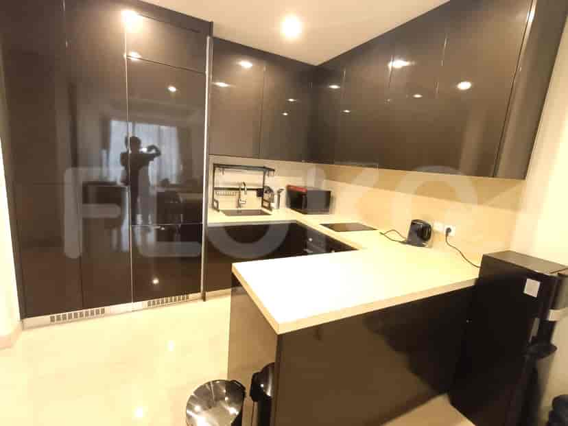Modern kitchen with dark brown cabinets and stainless steel appliances.