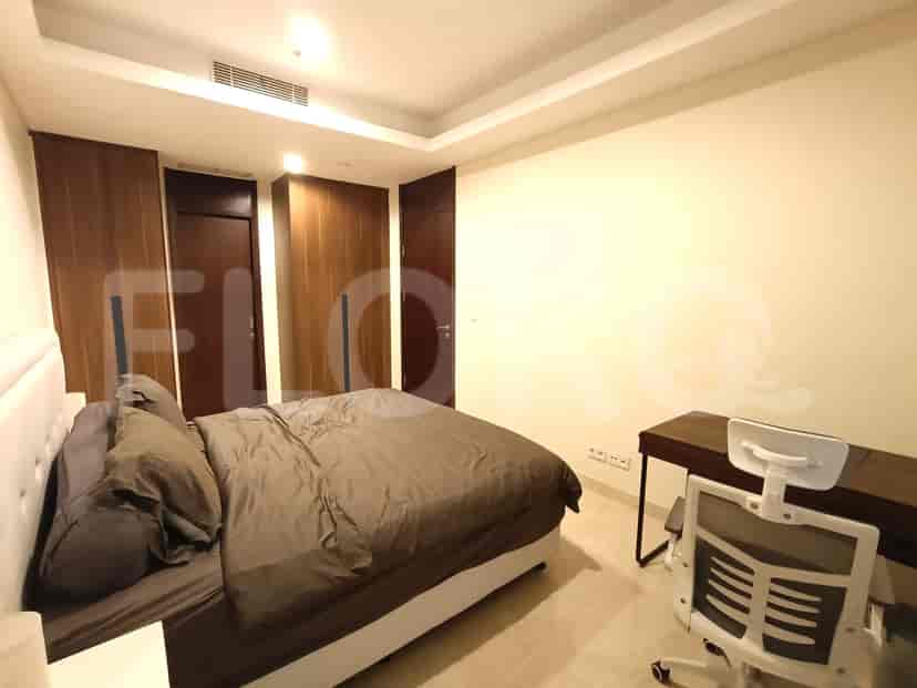 Bedroom with a bed, desk, and closet.