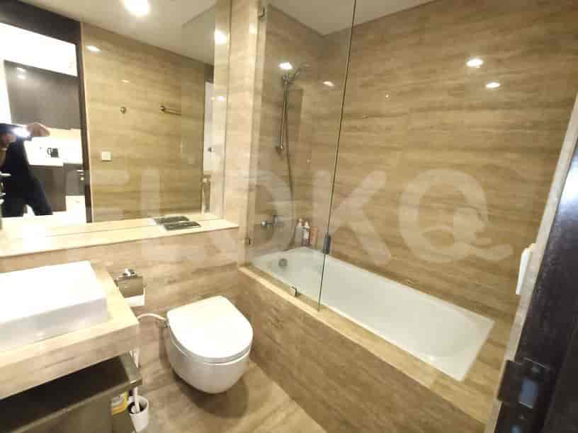 A luxurious bathroom with a bathtub and a glass shower door.