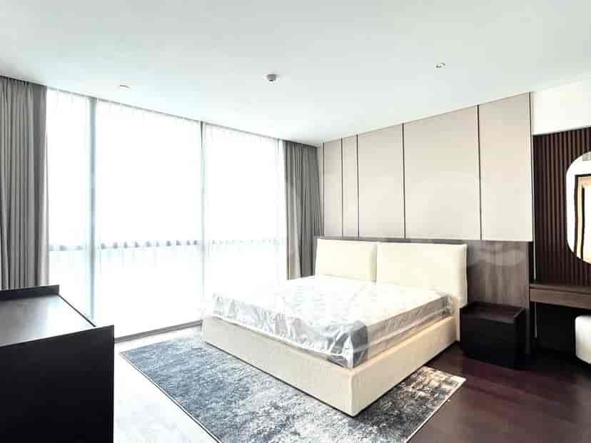 Bedroom with a bed, curtains, and a minimalistic design.