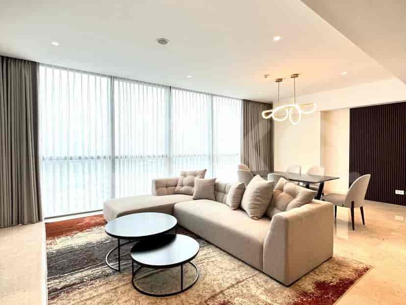 Dining area with a dark wooden table, pendant light, and a view of the city.
