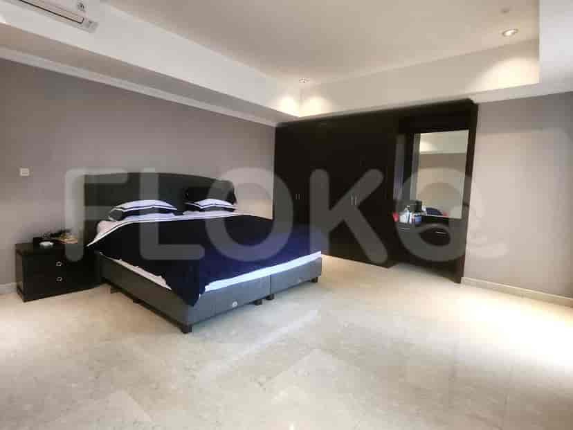A bedroom with a king-size bed, wardrobe, and dressing table.