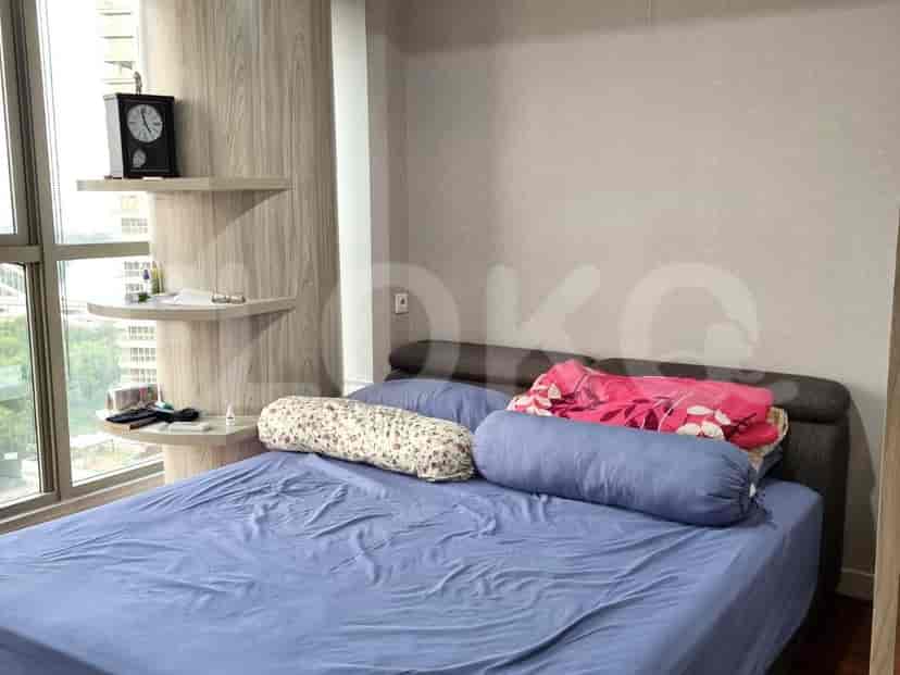 A cozy bedroom with a double bed and floating shelves.