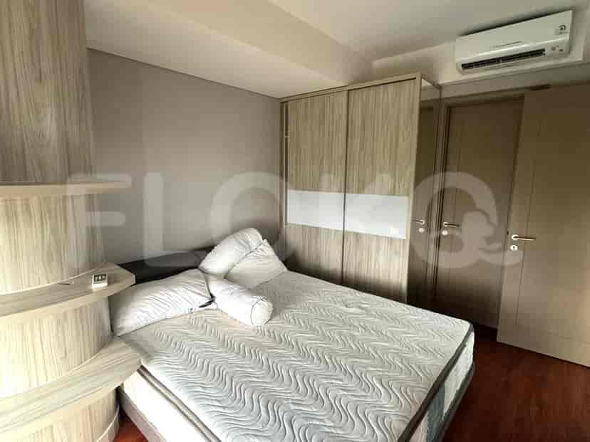 A bedroom with a double bed and wardrobe.