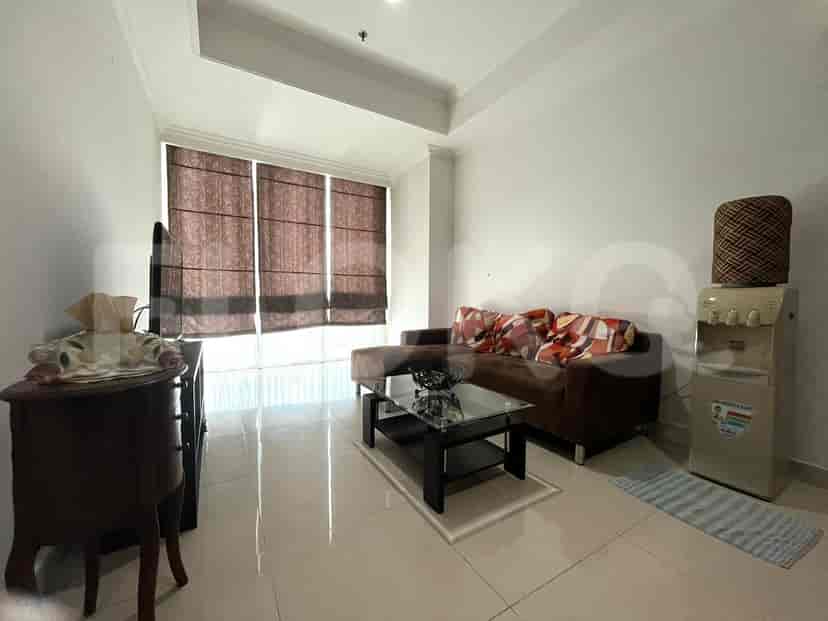 Living room with a brown sofa, coffee table, and window with blinds.