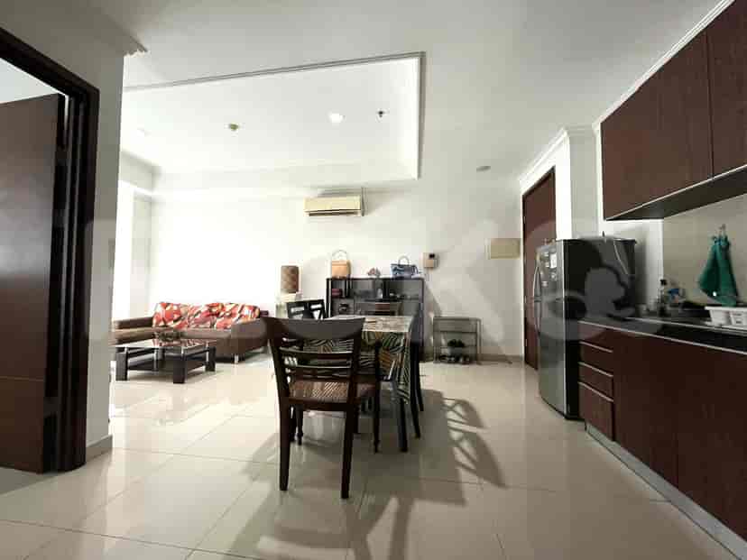 View of the dining area with a dining table, kitchen, and living room visible.