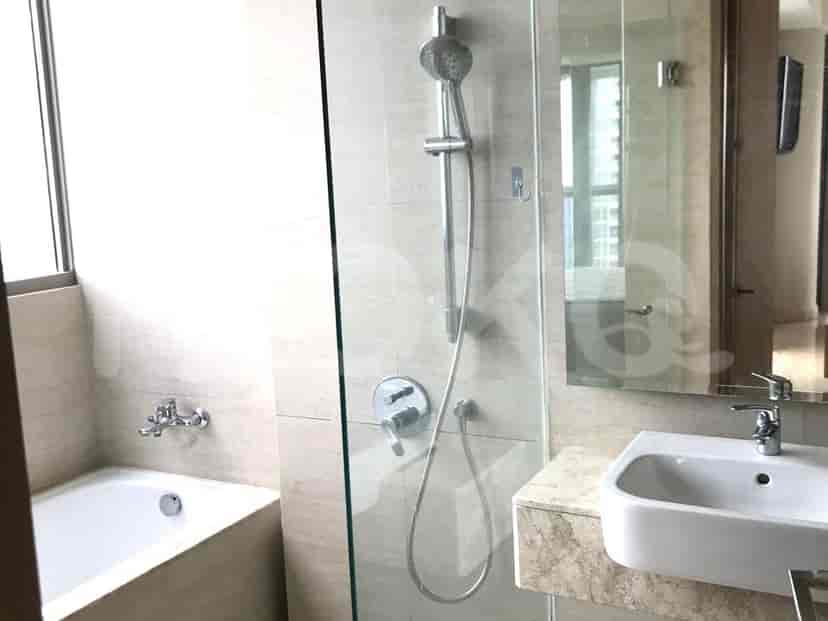 A luxurious bathroom with a shower area, bathtub, and marble finishes.