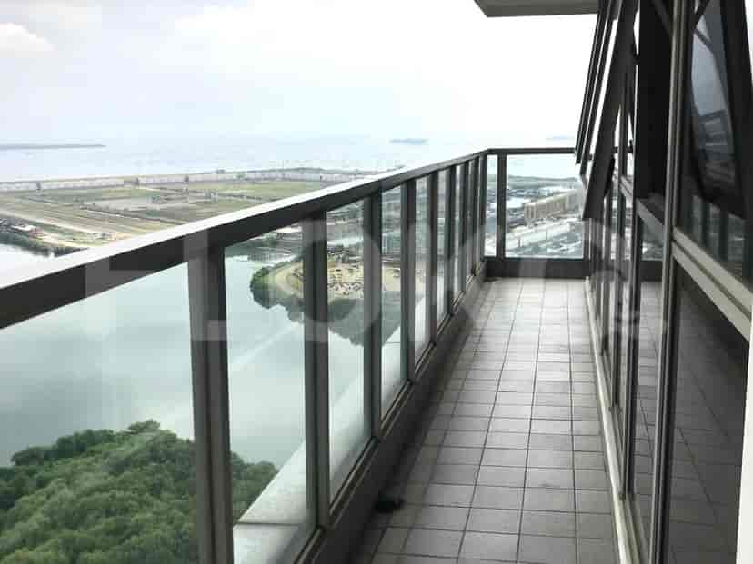 A balcony with a glass railing offering a clear view.