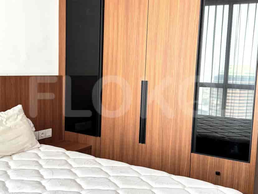 A modern bedroom featuring a bed and a large closet.