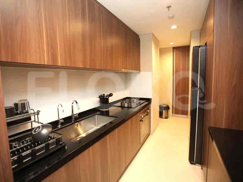 A modern kitchen with wooden cabinets and appliances.