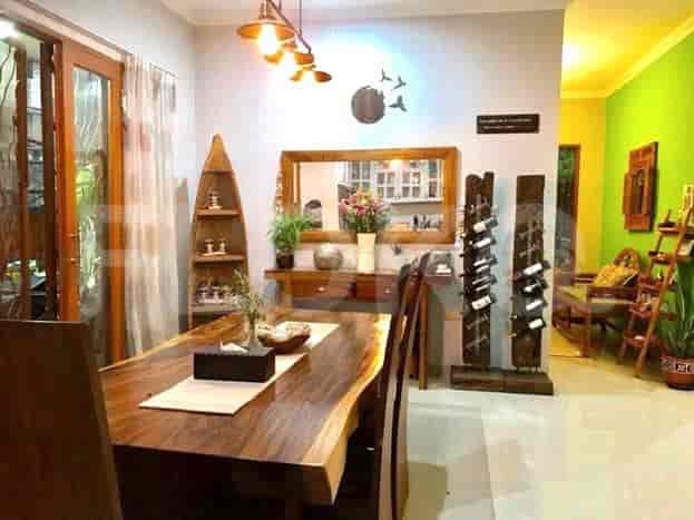 Dining room featuring a wooden dining table with chairs, wooden shelving, and a mirror.