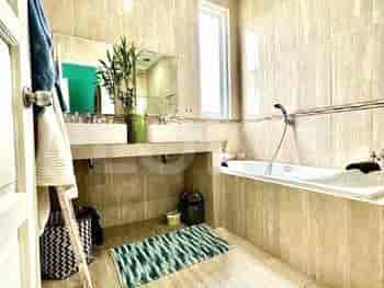A modern bathroom with a bathtub, double sink vanity, and a large mirror.