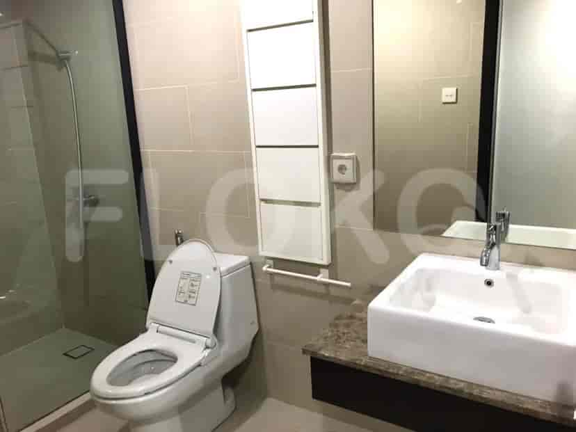 A bathroom with a toilet, sink, and shower.