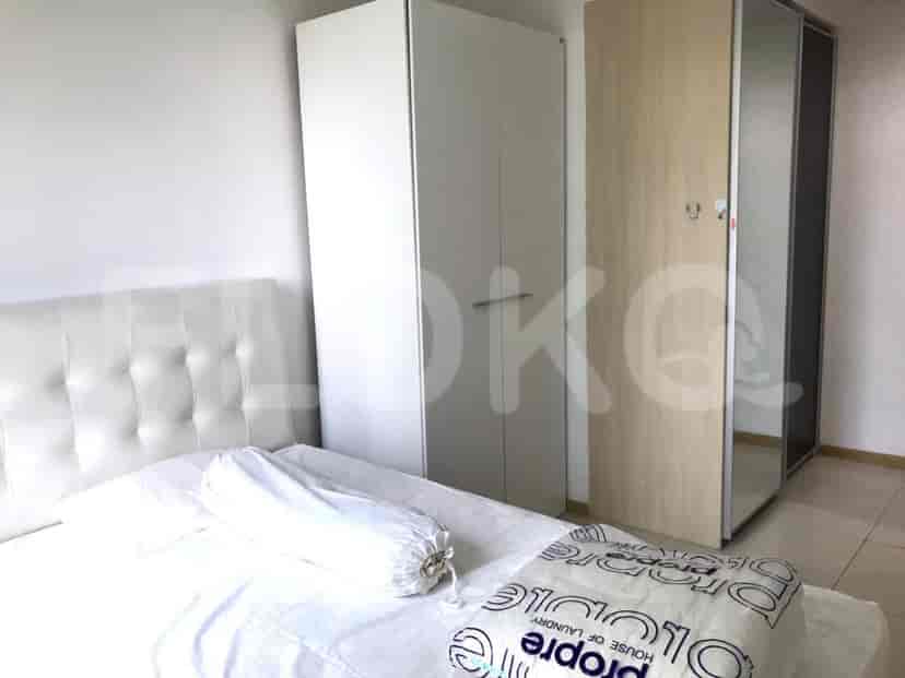 Another view of the bedroom, showing a closet and bed.