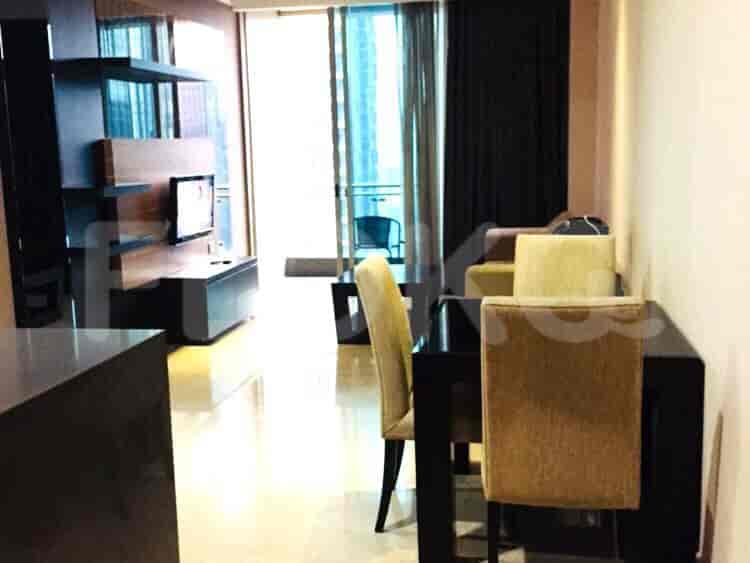 Modern living room with a dining area and entertainment center.
