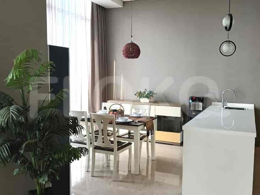Open-concept dining area and kitchen with a dining table and modern appliances.