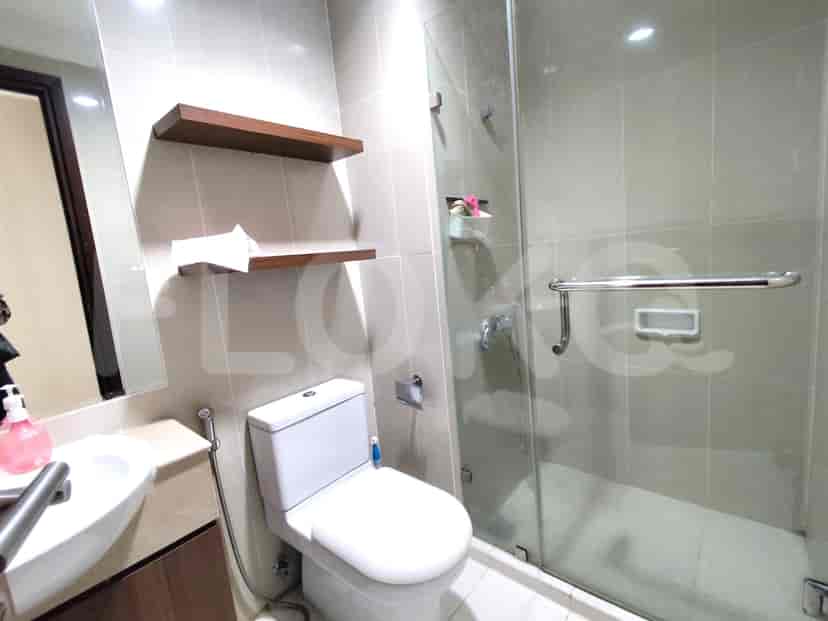 Modern bathroom with a shower, toilet, and sink.