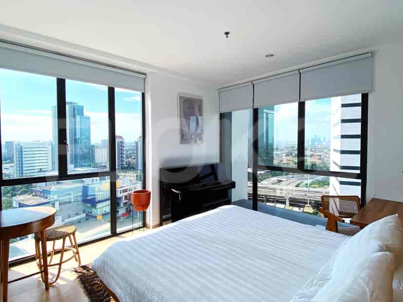 A bedroom with a large window, a piano, and a bed.