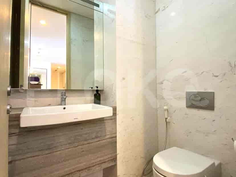 A bathroom with a mirror and white fixtures.