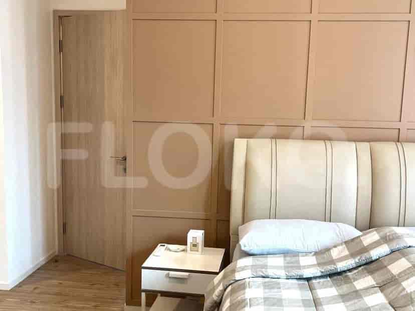 Modern bedroom with a bed and wooden paneling.