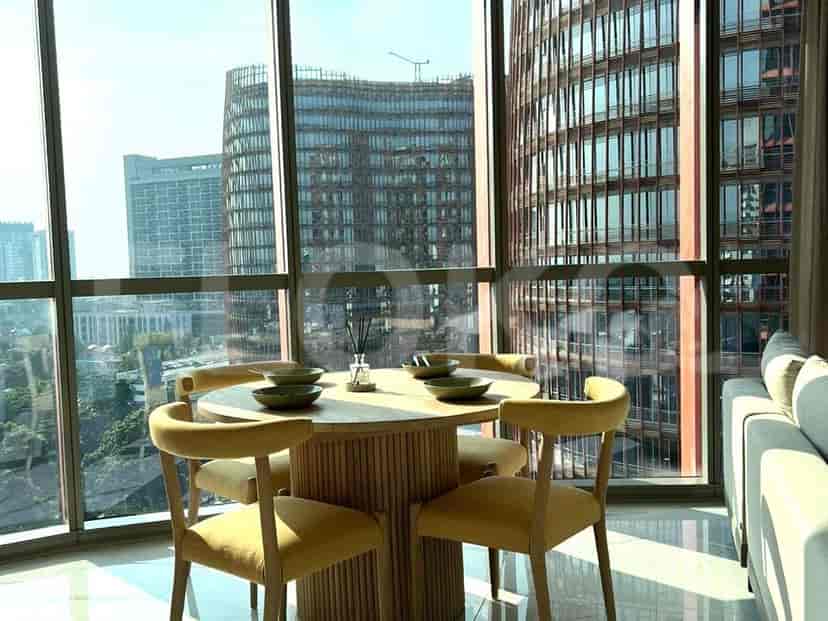 Dining area with a round table and city view.