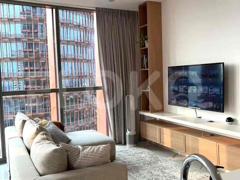 Living room with a large window overlooking the city.