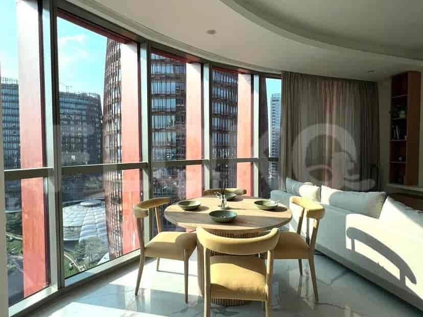 Dining area with a round wooden table and chairs.