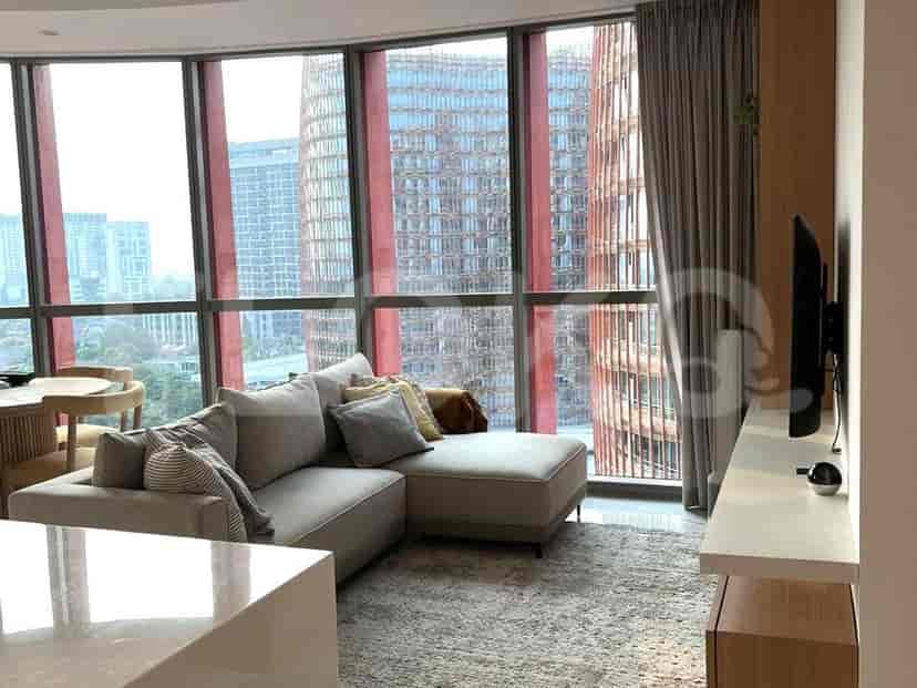 Living room with sofa, dining area, and city view.