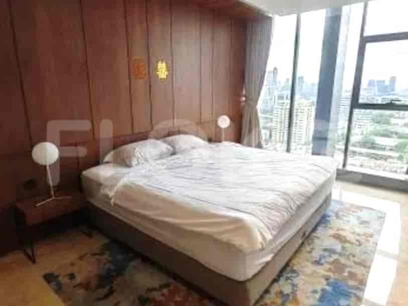Modern bedroom with a king-sized bed, wooden wall paneling, and a city view.