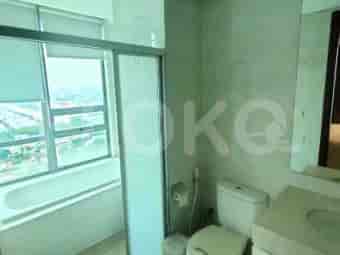 Bathroom with a bathtub and a large window offering a city view.