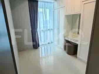 Walk-in closet with built-in cabinets and a vanity.